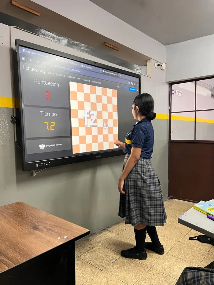 Estudiante del colegio Juan XXIII practicando coordenadas de ajedrez en la pizarra digital del aula